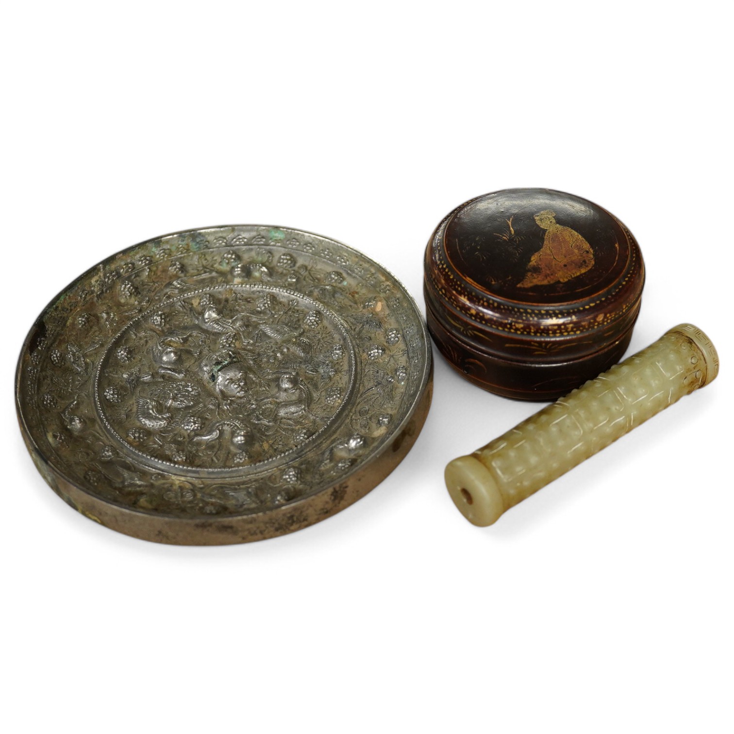 A Chinese silvered bronze mirror, a lacquer box and a jade cylindrical bead, largest 15cm diameter. Condition - fair to good